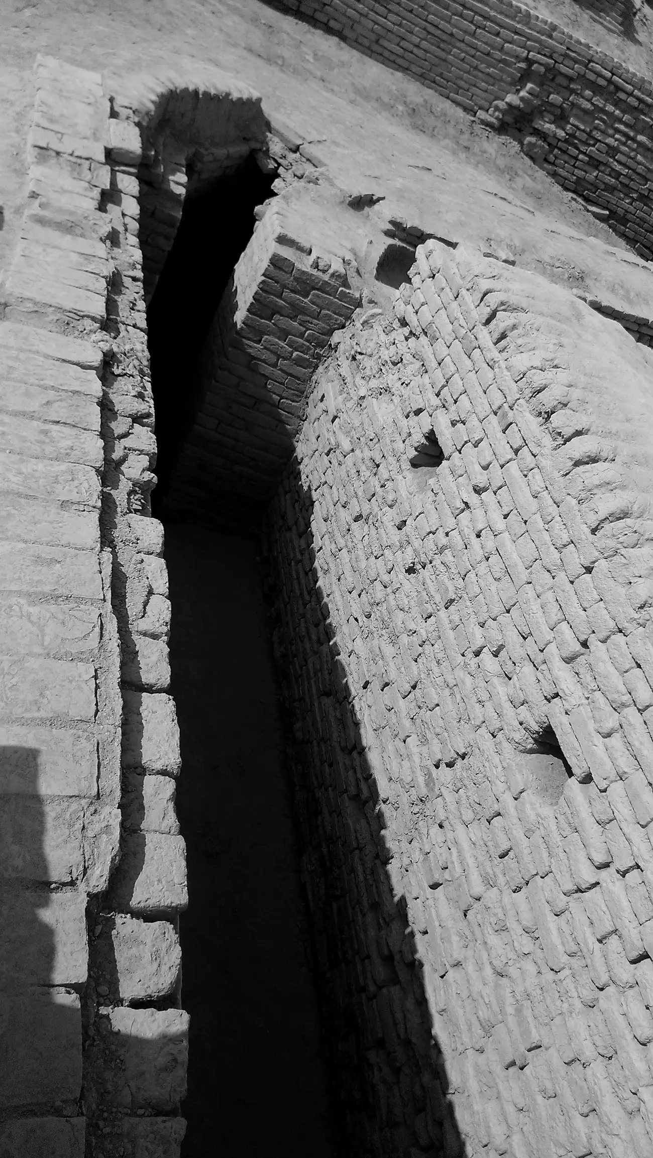An engineered brick water channel among the ruins of Mohenjo-daro