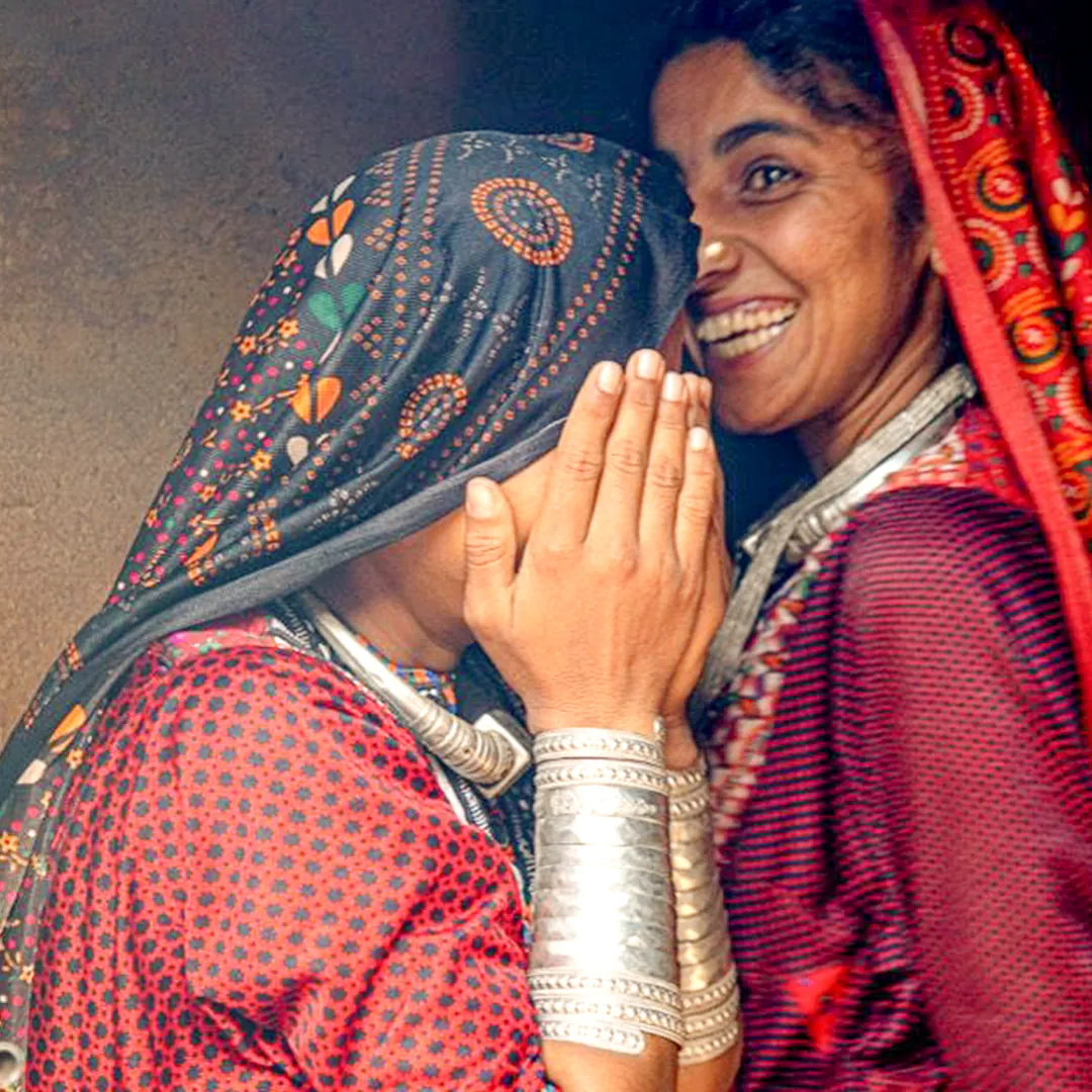 Two women in bandhani, silver at the wrist